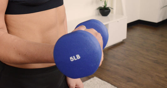 a women holding dumbbell