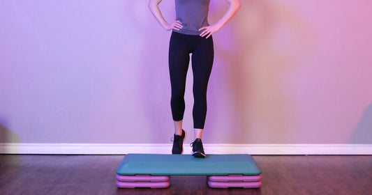 Sunny trainer is working out on aerobic step