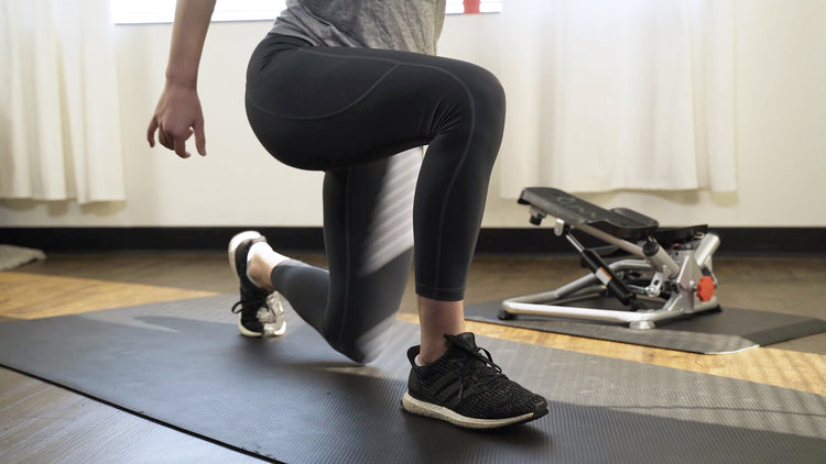 Sunny trainer exercising with mini steppers