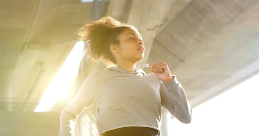 a woman is running under sunshine