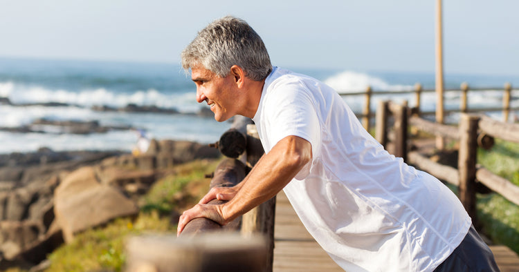 an elder person is doing pushups outdoors