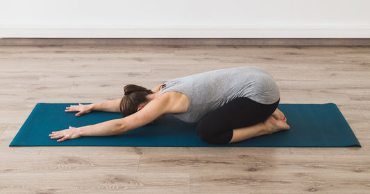 a working who is working out is doing child's pose
