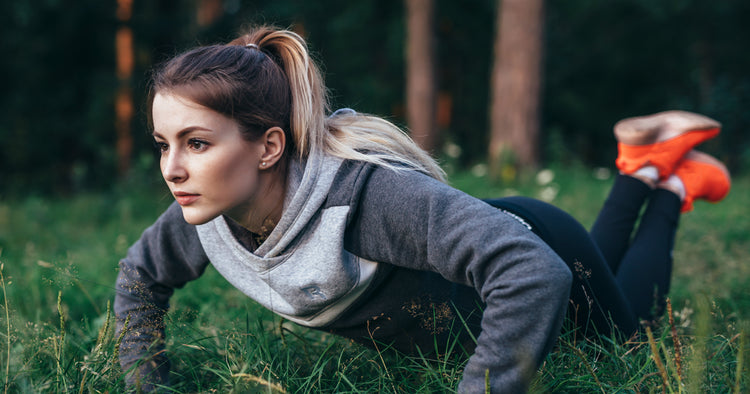 a woman is doing knee pushup