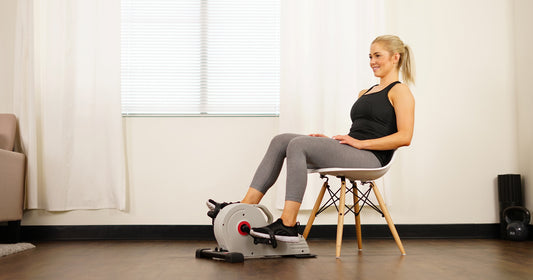 a woman is pedaling an under desk bike