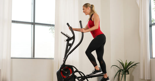 a woman is using elliptical