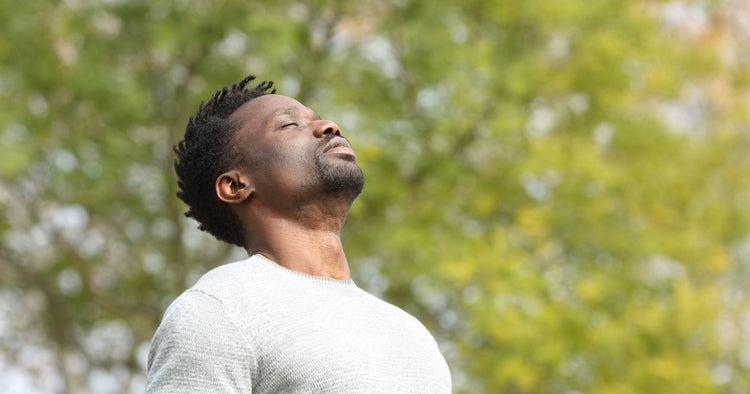 a man is breathing outdoors