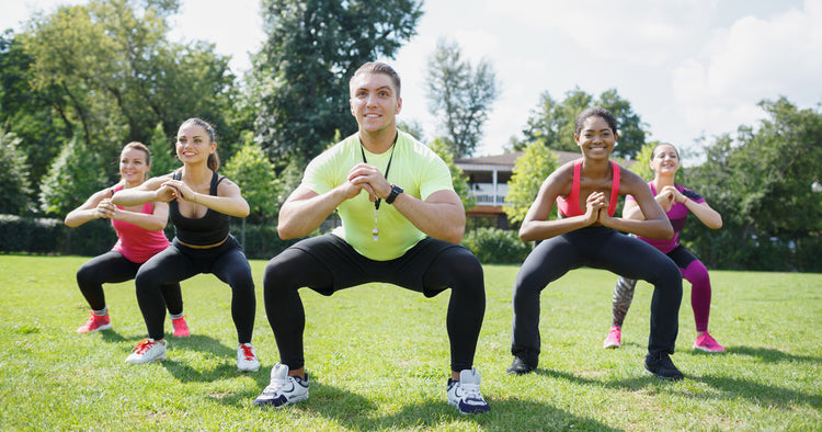 a group of people are working out outdoors