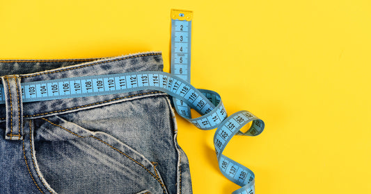 a jean with scale on waist on a yellow background