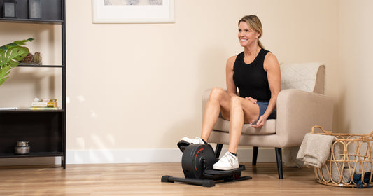 Woman on mini elliptical to help sore muscles after summer workout