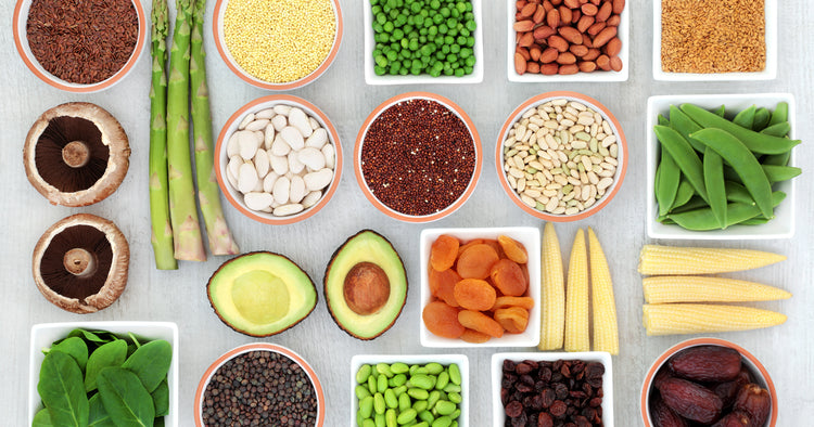 different vegetables and nuts in different bowls orderly on the table